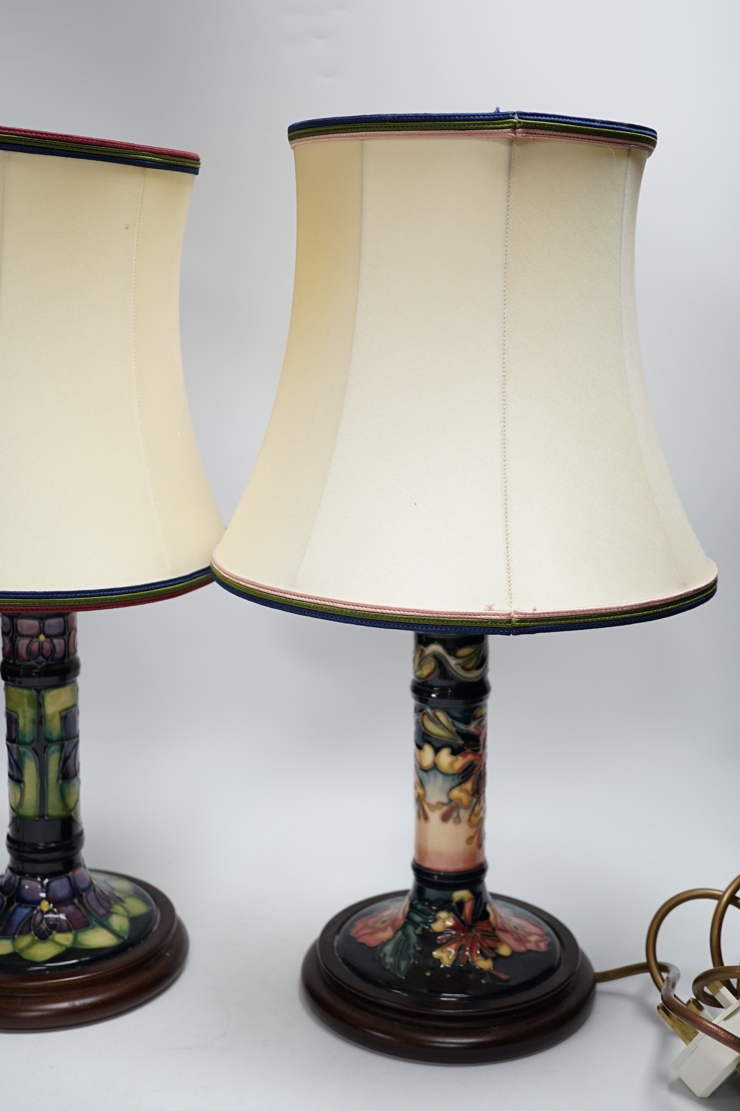Two Moorcroft lamp bases, in Oberon and Violet patterns, 47cm high
